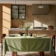 Olive Green Rectangular Velvet Tablecloth in a Contemporary Kitchen with Walnut Cabinetry and Beige Tile Backsplash