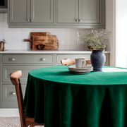 Emerald Green Velvet Round Tablecloth in a Cottage Kitchen with Soft Sage Cabinetry and White Tiles
