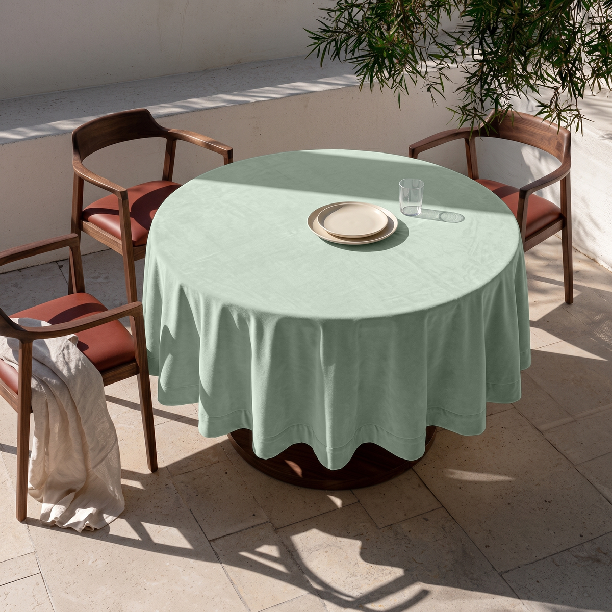 Mint Green Round Velvet Tablecloth in an Outdoor Dining Area with Stone Flooring and Walnut Chairs Accents