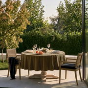 Olive Brown Round Velvet Tablecloth in an Outdoor Dining Area with Garden Views and Light Patio Chairs