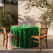 Lime Green Round Velvet Tablecloth on a Sunny Patio with White Stucco Walls and Cane Chairs