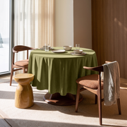 Moss Green Round Velvet Tablecloth in a Modern Dining Room with Walnut Paneling and Rust Upholstered Chairs