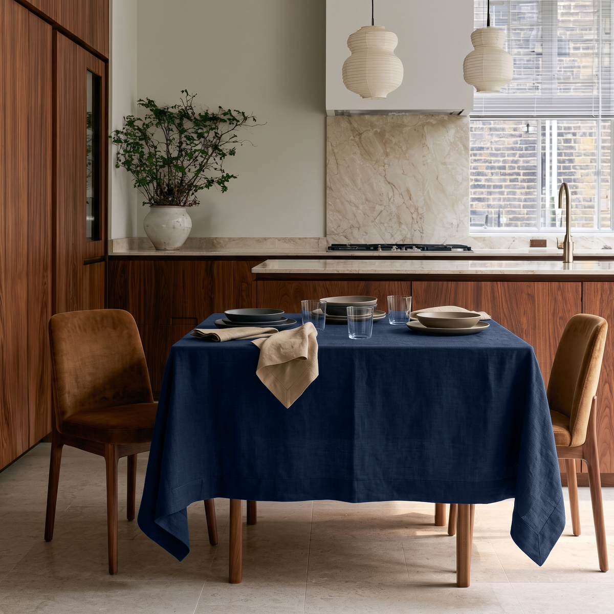 Royal Blue Square Linen Tablecloth in a Contemporary Kitchen with Walnut Cabinetry and Marble Backsplash
