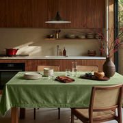 Sage Green Rectangular Velvet Tablecloth in a Contemporary Kitchen with Walnut Cabinetry and Cane Chairs