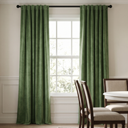 Elegant dining room with sage green back-tab curtains, classic furniture, and soft natural light.
