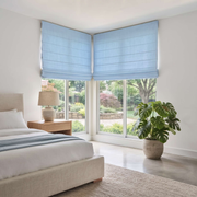 Sky Blue Cordless Linen Roman Blinds in a Contemporary Bedroom with Off-White Walls and a Upholstered Bed