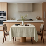 Ecru Square Heavy Weight Linen Tablecloth in a Minimalist Kitchen with Light Wood Cabinetry and Neutral Upholstered Chairs