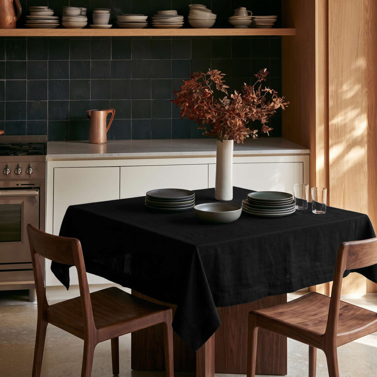 Black Square Linen Tablecloth in a Modern Kitchen with Dark Green Tile Backsplash and Walnut Wood Furniture