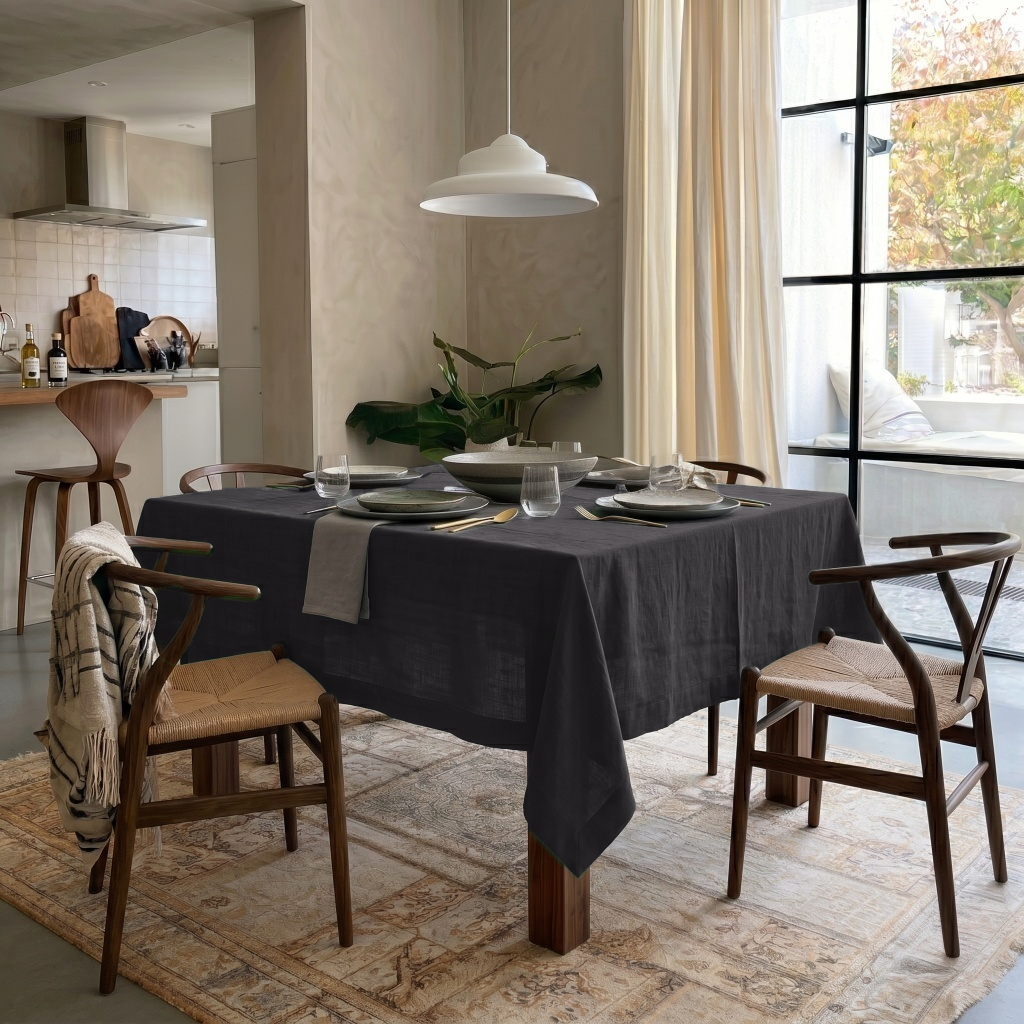 Charcoal Grey Square Linen Tablecloth in a Transitional Dining Room with Woven Wood Chairs