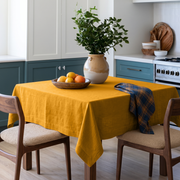 Mustard Yellow Square Linen Tablecloth in a Modern Farmhouse Kitchen with Blue Cabinetry