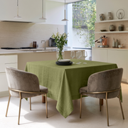 Olive Green Square Linen Tablecloth in a Modern Kitchen with Cream Cabinetry and Upholstered Dining Chairs