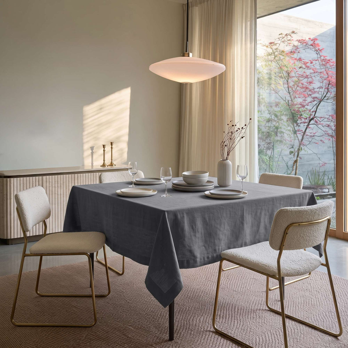 Dim Grey Square Linen Tablecloth in a Contemporary Dining Room with Cream Upholstered Chairs and Floor-to-Ceiling Windows