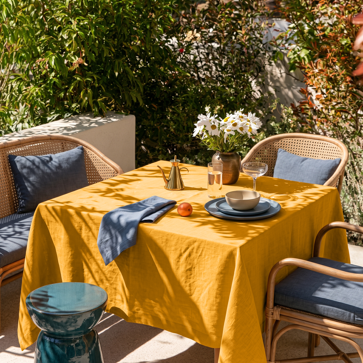 Mustard Yellow Square Linen Tablecloth in a Contemporary Outdoor Dining Area with Rattan Chairs