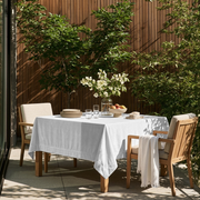 Off-White Square Velvet Tablecloth in a Modern Outdoor Dining Area with Wood Slat Wall