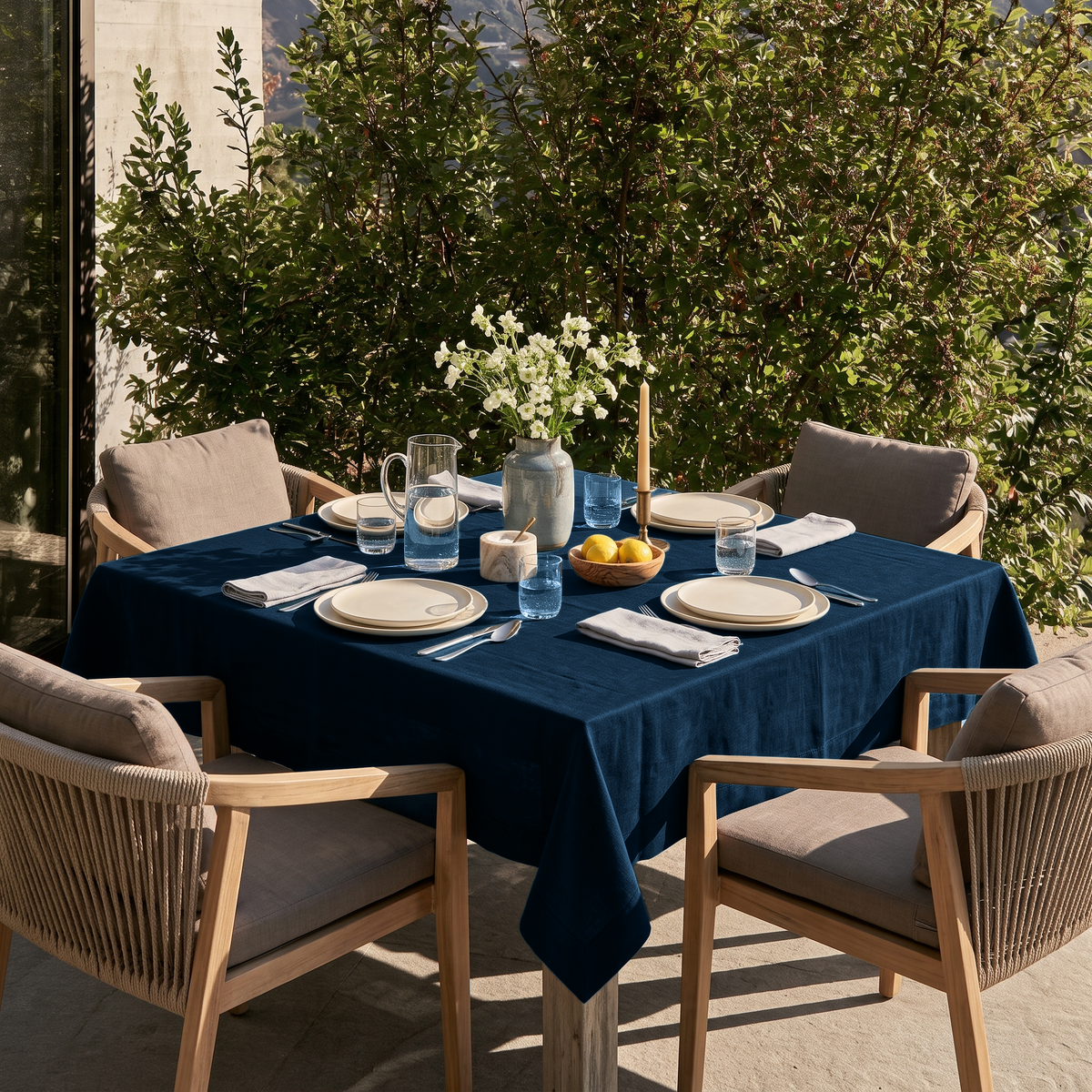 Peacock Blue Square Linen Tablecloth on a Contemporary Outdoor Patio with Wood-Framed Chairs