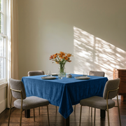 Steel Blue Square Velvet Tablecloth in a Contemporary Dining Room with Textured Chairs