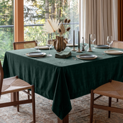 Hunter Green Square Velvet Tablecloth in a Contemporary Dining Room with Cane Chairs