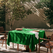 Lime Green Square Velvet Tablecloth in a Modern Outdoor Dining Area with Wooden Armchairs