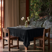 Steel Black Square Velvet Tablecloth in a Contemporary Dining Area with Floor-to-Ceiling Windows