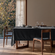 Steel Black Rectangular Velvet Tablecloth in a Mid-Century Modern Dining Room with Walnut Chairs and Floor-to-Ceiling Windows