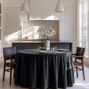 Steel Black Round Velvet Tablecloth in a Modern Kitchen Dining Area with White Cabinetry and Dark Stone Accents