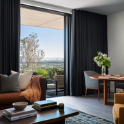 Steel Black Velvet S-Fold Sliding Patio Door Curtains in a Modern Living and Dining Room with a Rooftop Terrace