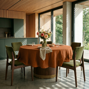 Terracotta Heavy Weight Linen Round Tablecloth in a Modern Kitchen Dining Space with Warm Wood Slat Walls and Olive Green Chairs