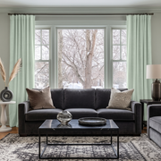 Mint Green Velvet Multitape Thermal Curtains in a Contemporary Living Room with Pale Grey Walls and a Charcoal Sofa