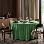 Fern Green Velvet Round Tablecloth in a Contemporary Dining Room with Dark Wood Slat Walls