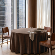 Chocolate Brown Velvet Round Tablecloth in a City Dining Room with Floor-To-Ceiling Windows and Brown Leather Chairs