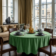 Fern Green Velvet Round Tablecloth in a Bright Dining Corner with Cream Walls and Brown Leather Chairs